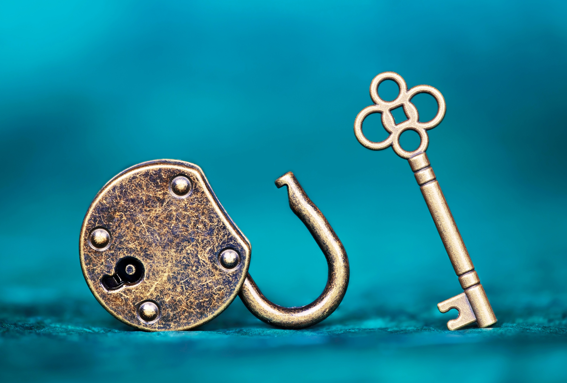 Success, solution, coaching concept, key and padlock on blue background